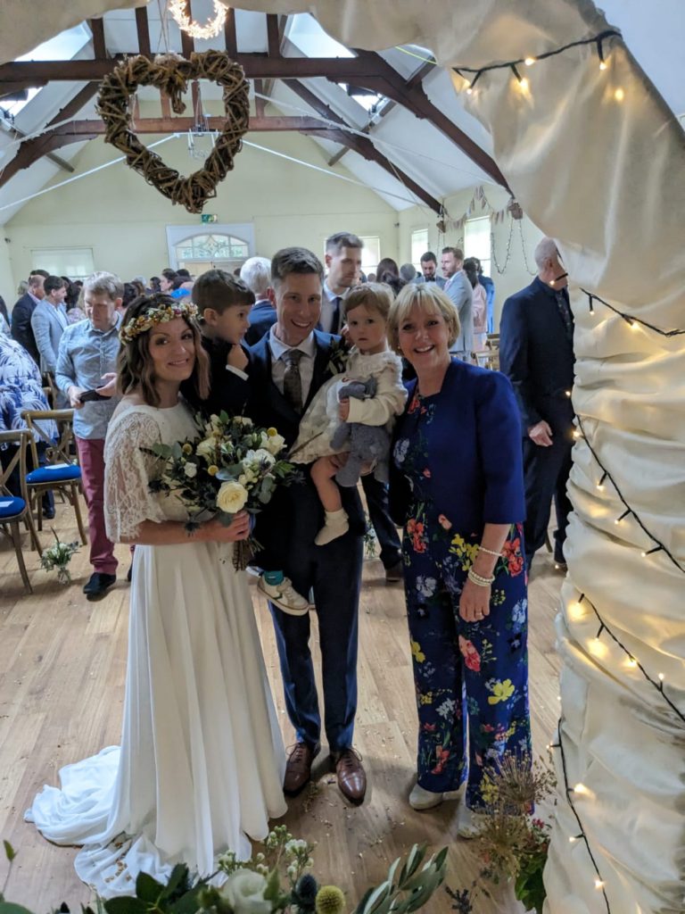 Couple with baby in arms tying the knot in Lancashire