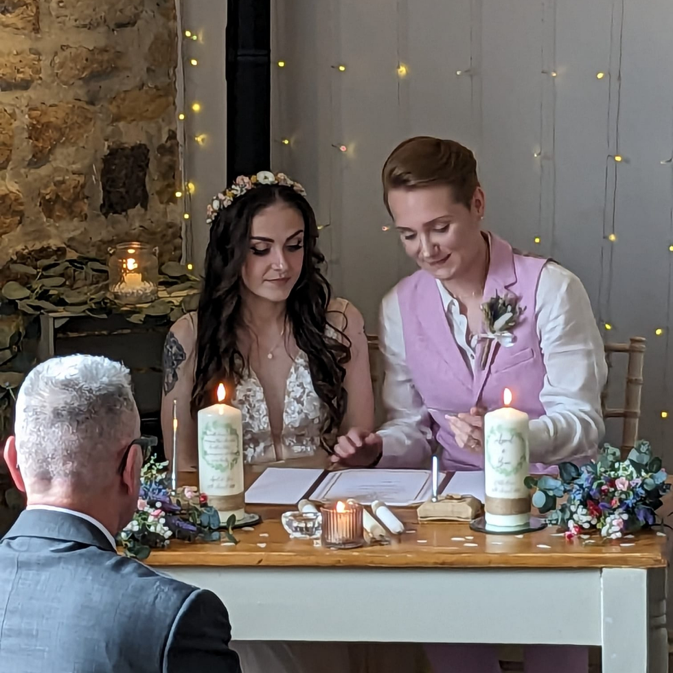 wedding couple sign vows in barn wedding
